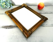 Vintage rattan mirror in frame.