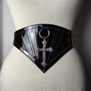 Waist belt "Miss". Gothic belt made with glossy pvc. O-ring and metallic cross on the front. Adjustable & Light boned.