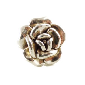 May include: A silver ring shaped like a rose with a textured surface.