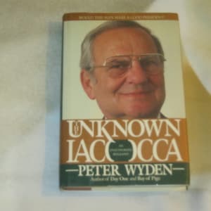 May include: A hardcover book titled "Unknown Iacocca" by Peter Wyden. The cover features a portrait of a man wearing glasses. The title is in large, bold letters with the subtitle "An Unauthorized Biography". The text "Would this man make a good president?" is at the top.