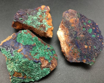 May include: Three rough, irregular shaped pieces of malachite and azurite. The stones are a mix of green, blue, and brown.