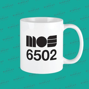 May include: White ceramic mug with a black logo that says "MOS 6502".