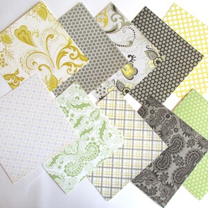 May include: Assortment of patterned scrapbook paper in various shades of green, yellow, and gray. The patterns include paisley, polka dots, and geometric designs.