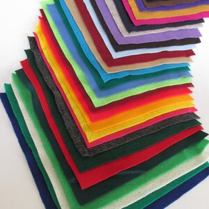 May include: A stack of felt squares in various colors, including red, green, blue, yellow, orange, and purple. The felt squares are arranged in a rainbow pattern.