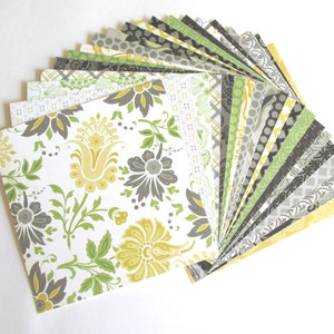 May include: A fan of patterned paper squares in shades of green, yellow, and gray. The papers feature various floral and geometric designs.