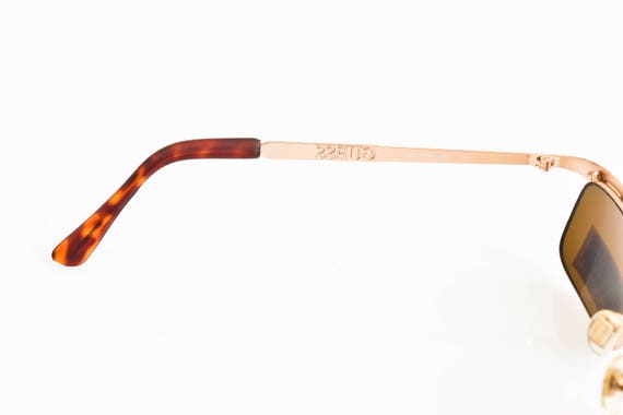 Where are guess sales sunglasses made
