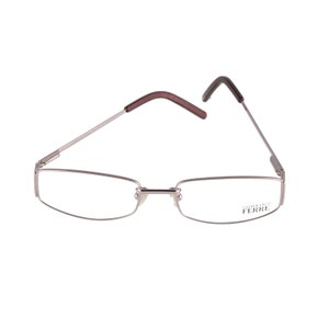 May include: Silver-toned eyeglasses with a rectangular frame and brown temples. The brand name "Gianfranco Ferre" is printed on the right temple.