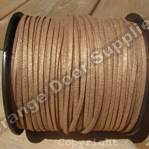 May include: A spool of brown faux leather cord with a glittery finish. The cord is wound tightly around a black plastic spool.