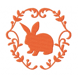 May include: Orange embroidered design of a rabbit inside a floral wreath.