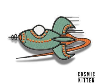 May include: A green and orange embroidered patch of a cartoon rocket ship with a white window and a trail of smoke behind it. The text "COSMIC KITTEN" is below the rocket.