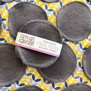 May include: Gray reusable facial rounds made of 100% cotton. The rounds are machine washable and eco-friendly. The packaging says "Farm Girl Design Facial Rounds 100% Cotton - Eco Friendly".