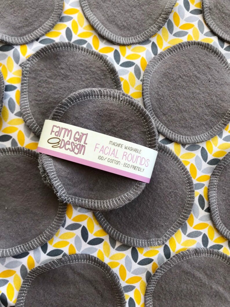 May include: Gray reusable facial rounds made of 100% cotton. The rounds are machine washable and eco-friendly. The packaging says "Farm Girl Design Facial Rounds 100% Cotton - Eco Friendly".