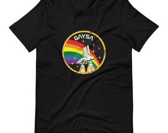 May include: Black t-shirt with a distressed, circular patch featuring a rainbow, a space shuttle, and the text "GAYSA".