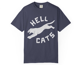 May include: Navy blue t-shirt with a distressed white graphic. The graphic features a leaping cougar and the words "HELL CATS" in a circular design. The shirt is made of a soft material.