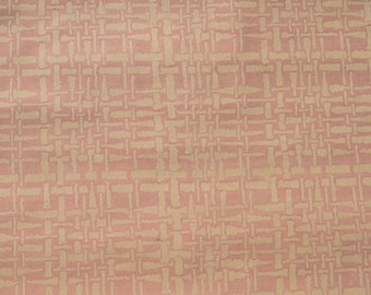 May include: A pink fabric with a beige woven pattern. The fabric has a subtle texture and a slightly wrinkled appearance.