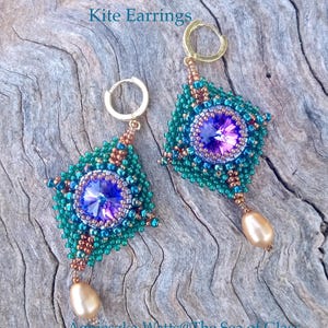 May include: A pair of handmade kite earrings. The earrings feature a teal and copper beaded design with a large purple and blue crystal center. Each earring has a gold-colored hoop and a dangling pearl-shaped bead. The text "Kite Earrings" is at the top.