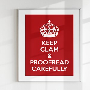 May include: A framed poster with a red background and a white crown at the top. The text on the poster reads "Keep Calm & Proofread Carefully".