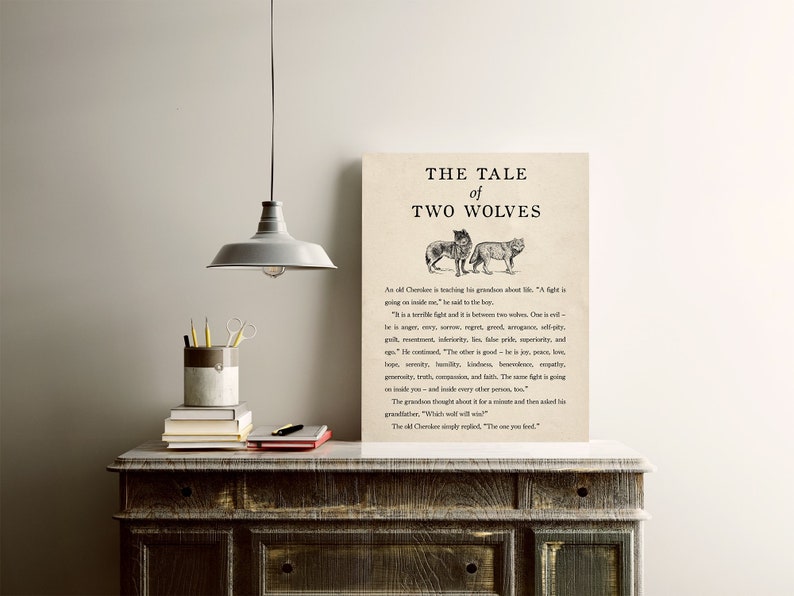May include: A black and white illustration of two wolves, one with a more aggressive expression and the other with a more peaceful expression. The text "The Tale of Two Wolves" is at the top of the image. The text below the image reads: "An old Cherokee is teaching his grandson about life. "A fight is going on inside me," he said to the boy. "It is a terrible fight and it is between two wolves. One is evil - he is anger, envy, regret, greed, arrogance, self-pity, guilt, resentment, inferiority, lies, false pride, superiority, and  jealousy. The other is good - he is joy, peace, love, serenity, humility, kindness, benevolence, empathy, generosity, truth, compassion, and faith. The same fight is going on inside you and inside every other person, too." The grandson thought about it for a minute and then asked his grandfather, "Which wolf will win?" The old Cherokee simply replied, "The one you feed."