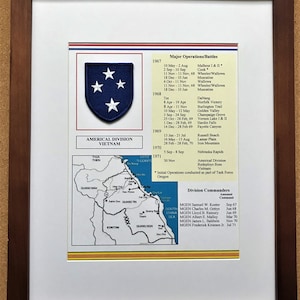 May include: Framed print featuring the Americal Division Vietnam emblem, a blue shield with four white stars. Includes a map of Vietnam with military operation locations and a list of major battles and division commanders.