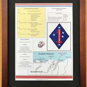 May include: Framed print of the 1st Marine Division 1941-1945, featuring campaigns, major battles, order of battle, and a map of Guadalcanal. Includes a patch with the text "Guadalcanal". The frame is dark brown.