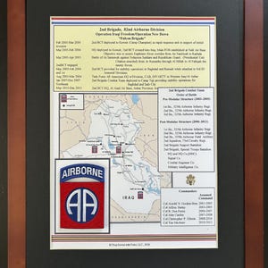 May include: A framed military commemorative display featuring a map of Iraq, historical text regarding the 2nd Brigade 82nd Airborne Division, and a red and blue embroidered Airborne patch. The document includes unit structure and command lists.