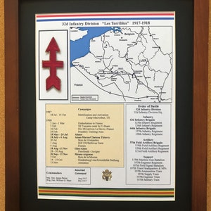 May include: Framed print of the 32nd Infantry Division "Les Terribles" during 1917-1918, featuring a map of France and Belgium. Includes a red arrow patch and detailed campaign information, commanders, and order of battle.