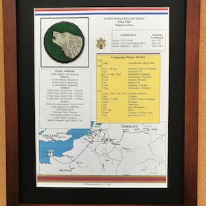 May include: Framed print of the 104th Infantry Division, nicknamed the Timberwolves, from 1944-1945. The print includes the division's emblem, order of battle, commanders, campaigns, and a map of their movements in Europe.