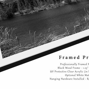 May include: A black and white photograph of a lake and trees framed in a black wood frame with a white mount. The frame is 1.25 inches wide and includes UV protective clear acrylic instead of glass. The print comes with hanging hardware installed and is ready to hang.