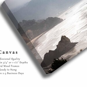 May include: A canvas print of a misty seascape with a rocky coastline and waves crashing on the shore. The print is available in 3/4 inch or 1 1/2 inch depths with solid wood frames.