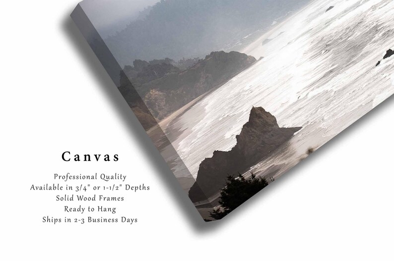 May include: A canvas print of a misty seascape with a rocky coastline and waves crashing on the shore. The print is available in 3/4 inch or 1 1/2 inch depths with solid wood frames.