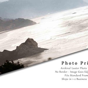 May include: A photo print of a misty seascape with a rocky coastline and a beach. The image is printed on archival luster photo paper with no border, and the image goes edge to edge. The print is suitable for standard frames and ships in 1-2 business days.