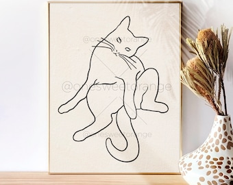 May include: Line art print of a cat in a curled up position. The print is on a beige background and is framed in a light wood frame.