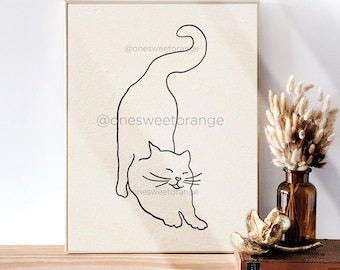 May include: A black and white line drawing of a cat on a beige background. The cat is in a playful pose with its tail curled up and its head tilted to the side. The drawing is framed in a light brown frame.