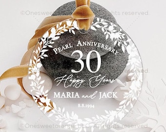 May include: A clear round ornament with a white floral wreath design. The ornament features the text "PEARL ANNIVERSARY 30 Happy Years MARIA and JACK 8.8.1994".
