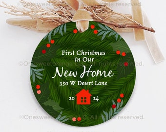May include: A green and red Christmas ornament with a house illustration and the text "First Christmas in Our New Home 350 W Desert Lane 20 24".
