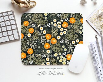 May include: A floral mouse pad with a dark green background and a pattern of orange and white flowers. The text "Hello Delicious." is printed in white at the bottom of the mouse pad.