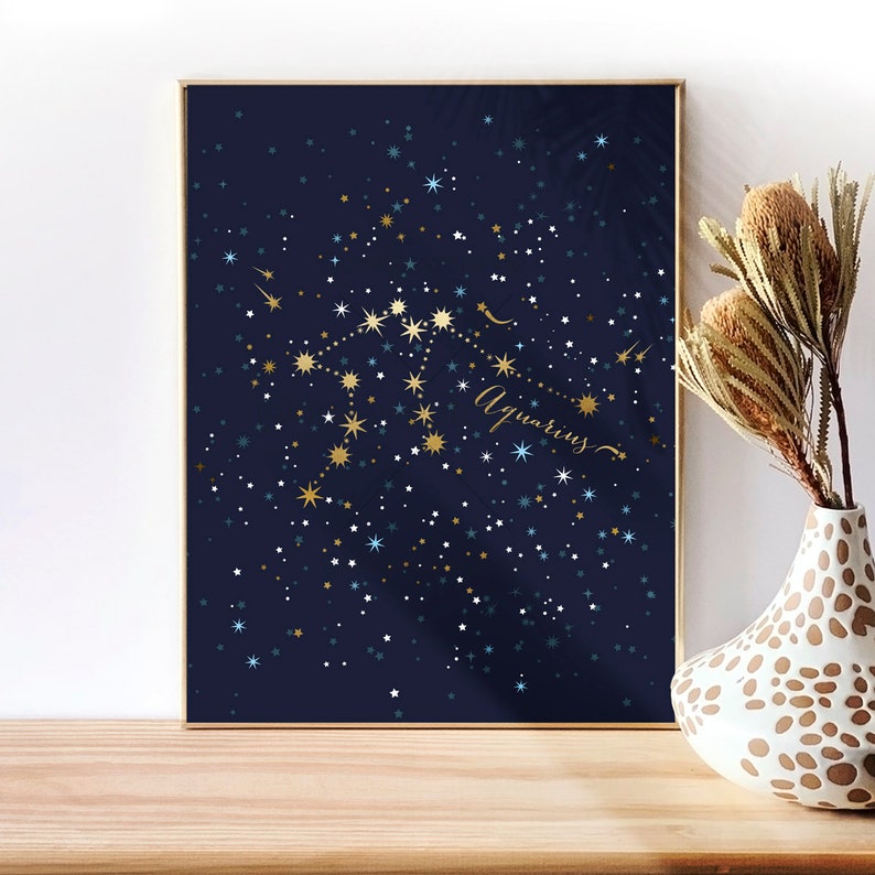 May include: A navy blue poster with gold and white stars depicting the Aquarius constellation. The word "Aquarius" is written in gold cursive script.