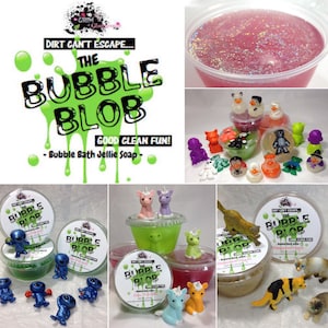 May include: A collection of colorful bath jellies in clear containers with various animal figurines. The containers are labeled "The Bubble Blob" and "Good Clean Fun!" with the tagline "Bubble Bath Jellie Soap".
