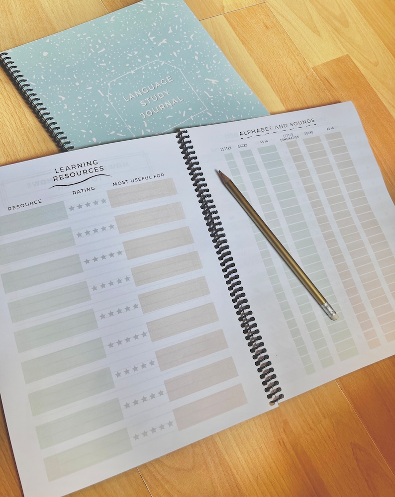 May include: A spiral bound journal with a light blue cover with white speckles. The cover has the text "Language Study Journal". The journal has a section for rating learning resources and a section for tracking alphabet and sounds.