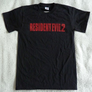 May include: Black t-shirt with the red text "RESIDENT EVIL 2" printed on the front.