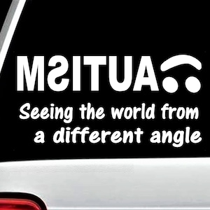 May include: A black and white sticker with the text "M2ITUA" and the words "Seeing the world from a different angle".