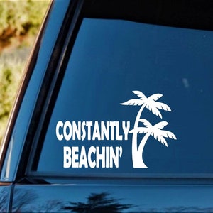 May include: White vinyl decal with the text "Constantly Beachin'" and a silhouette of two palm trees.