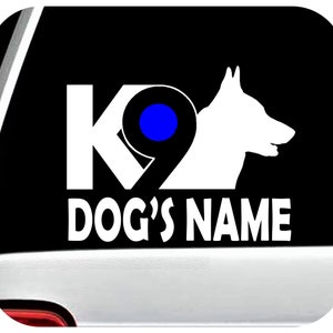 May include: White K9 decal with a blue circle and a silhouette of a German Shepherd dog's head. The text "DOG'S NAME" is below the K9.