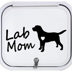 May include: Black and white decal with the text "Lab Mom" and a silhouette of a Labrador Retriever with a heart on its chest.