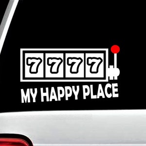 May include: A white decal with a slot machine graphic and the text "My Happy Place". The slot machine has three 7s lined up in a row. The slot machine has a red lever.