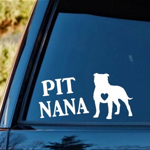 May include: White vinyl decal with a silhouette of a Pit Bull dog with a heart on its chest and the text "PIT NANA" on a blue car window.