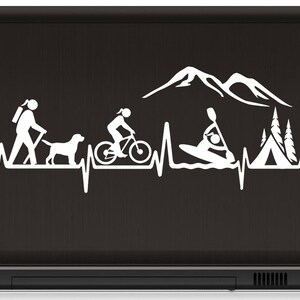 May include: White silhouette of a heartbeat with icons of hiking, biking, kayaking, camping, and mountains. The design is on a black laptop.