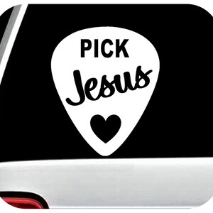 May include: White guitar pick shaped decal with the text "PICK Jesus" in black lettering and a black heart in the center.