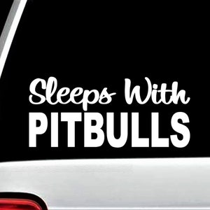 May include: White vinyl decal with the text "Sleeps With Pitbulls" on a black background.