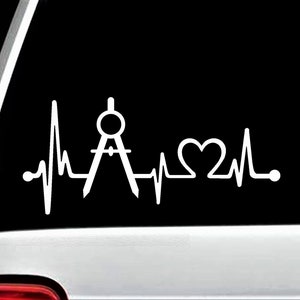 May include: White vinyl decal of a compass and a heartbeat with a heart in the middle. The decal is on a black background.